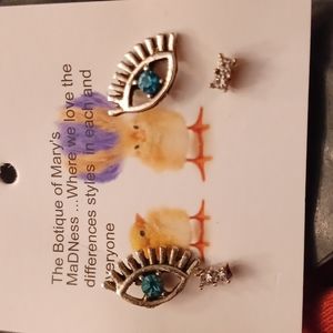 2 pair of high end earrings studs with " the eye" and acentuator earring